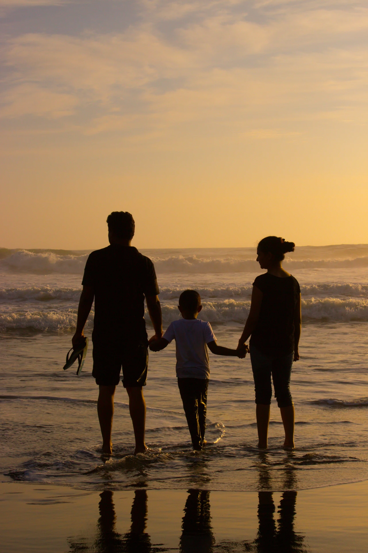 Family enjoying a beach holiday at sunset