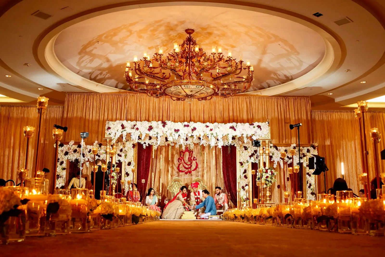 Indian wedding ceremony beneath a flower-decorated mandap